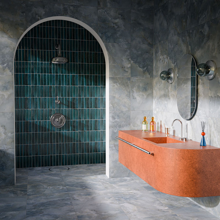 Bathroom featuring Levent Blue Fluted Decor 6cm x 24cm gloss porcelain tiles in the shower, showcasing deep blue tones and a textured fluted surface, paired with blue-grey wall and floor tiles and a statement terracotta basin.