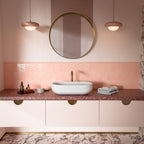 Liberty Blush Pink Bullnose Pencil Border 3cm x 20cm tiles, featuring a soft blush pink gloss finish used to create a neat border above coordinating pink wall tiles, paired with a terrazzo effect worktop and warm brass details.