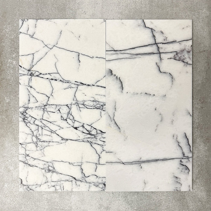Close-up of Fayrouz Lilac natural marble tiles in a honed finish, 30.5x61cm format, showcasing a soft white base with delicate lilac and grey veining, creating a subtle yet refined look for wall and floor applications.