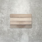 Close-up of Lisbon Grey 5cm x 30cm artisanal porcelain wall tiles arranged horizontally, showcasing warm grey and taupe tones, subtle tonal variation and a handcrafted-effect surface finish.