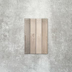 Close-up of Lisbon Grey 5cm x 30cm artisanal porcelain wall tiles arranged vertically, showcasing warm grey and taupe tones, subtle tonal variation and a handcrafted-effect surface finish.