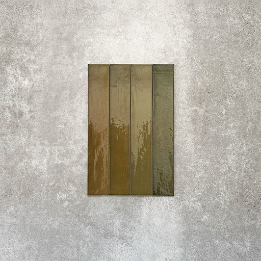 Close-up of Lisbon Olive Green 5cm x 30cm artisanal porcelain wall tiles arranged vertically, showcasing earthy olive green tones, subtle tonal variation and a glossy handcrafted-effect surface finish.