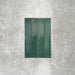 Close-up of Lisbon Verde Green 5cm x 30cm artisanal porcelain wall tiles arranged vertically, showcasing rich green tones, subtle tonal variation and a glossy handcrafted-effect surface finish.