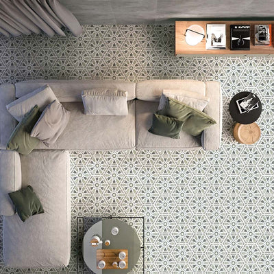 Living room featuring Medina Hormuz Sage Green/Grey Moroccan-style hexagon porcelain floor tiles, 18.7 × 21.6 cm, laid in a striking geometric pattern and styled with modern seating and soft neutral furnishings.