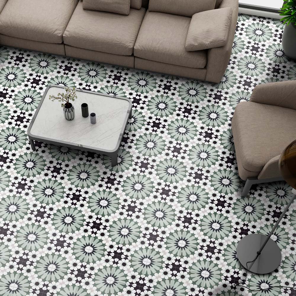 Fez Orchid Moroccan style porcelain floor tiles with a repeating geometric star pattern in soft green, black and white, styled in a living room setting