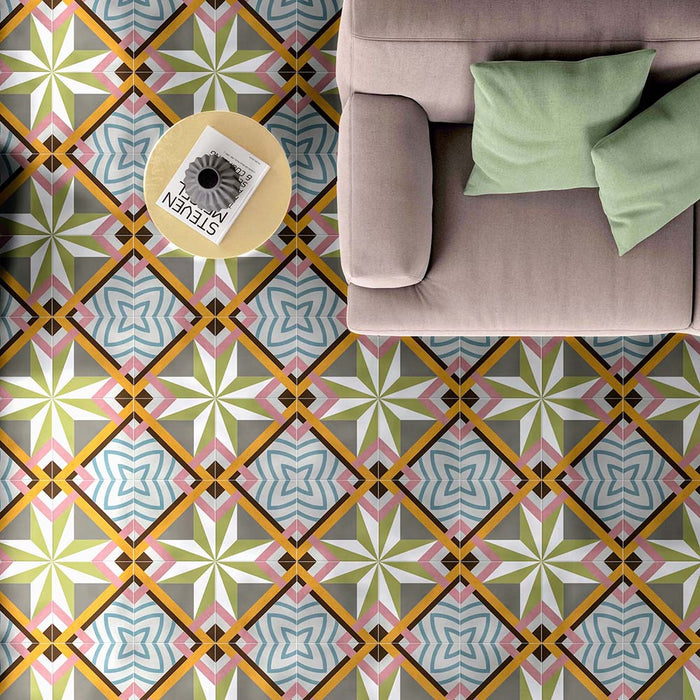 Living room interior featuring Cuba Star Moroccan-style porcelain floor tiles in a 20×20cm square format, displaying a bold geometric star pattern in soft green, blue, pink and mustard tones, styled with a neutral sofa and pastel cushions to create a bright, contemporary space with vintage character.