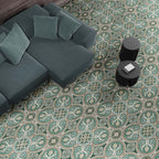 Living room interior featuring London Streets Regent Street 20x20cm Victorian Moroccan style floor tiles, styled with a modern sofa, soft cushions and round black side tables, showcasing an elegant green and cream patterned floor.