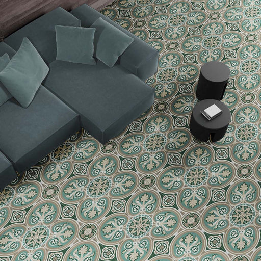 Living room interior featuring London Streets Regent Street 20x20cm Victorian Moroccan style floor tiles, styled with a modern sofa, soft cushions and round black side tables, showcasing an elegant green and cream patterned floor.