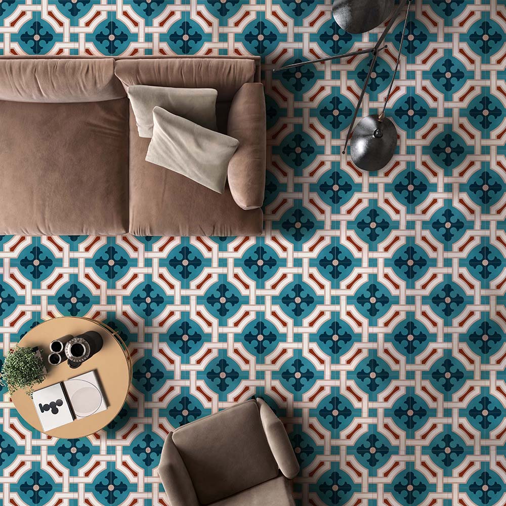 Living room interior featuring London Streets Leicester Square 20x20cm Victorian Moroccan style floor tiles, styled with a neutral sofa, armchair, round coffee table and modern floor lamp, showcasing a bold teal and cream patterned floor.