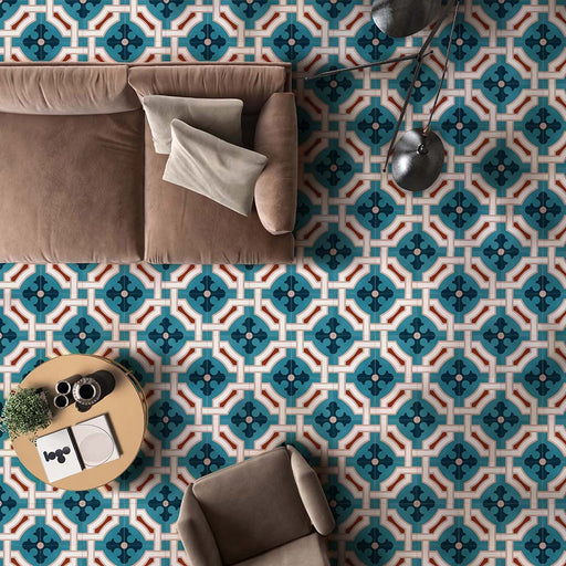 Living room interior featuring London Streets Leicester Square 20x20cm Victorian Moroccan style floor tiles, styled with a neutral sofa, armchair, round coffee table and modern floor lamp, showcasing a bold teal and cream patterned floor.