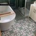 London Streets Bond Street 20cm x 20cm Victorian and Moroccan style tiles, featuring an intricate green, black and neutral pattern across this characterful bathroom floor.