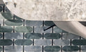 Close-up of Lucca Abacus 3D Décor 60 × 120cm porcelain wall and floor tiles, showcasing an elongated geometric pattern in soft green and marble-effect tones with a bold contemporary decorative finish.