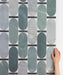 Close-up of Lucca Abacus 3D Décor 60 × 120cm porcelain wall and floor tiles, showcasing an elongated geometric pattern in soft green and marble-effect tones with a bold contemporary decorative finish.