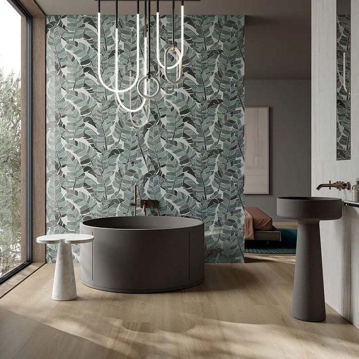 Luxury bathroom featuring Lucca Bali 3D Décor 60 × 120cm porcelain wall tiles, showcasing layered tropical leaf patterns in soft green tones, paired with contemporary black sanitaryware and warm wood finishes.