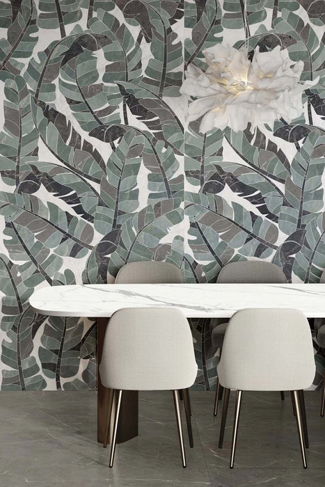 Dining area featuring Lucca Bali 3D Décor 60 × 120cm porcelain wall tiles, showcasing layered tropical leaf patterns in soft green and charcoal tones, paired with contemporary furniture and elegant modern interiors.