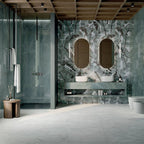 Luxury bathroom featuring Lucca Bali 3D Décor 60 × 120cm porcelain wall tiles, showcasing layered tropical leaf patterns in soft green tones, paired with marble-effect surfaces and contemporary spa-inspired interiors.