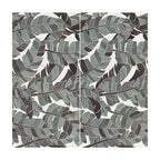 Flat lay of Lucca Bali 3D Décor 60 × 120cm porcelain wall and floor tiles, featuring layered tropical leaf patterns in soft green, grey, and charcoal tones with a bold decorative finish.