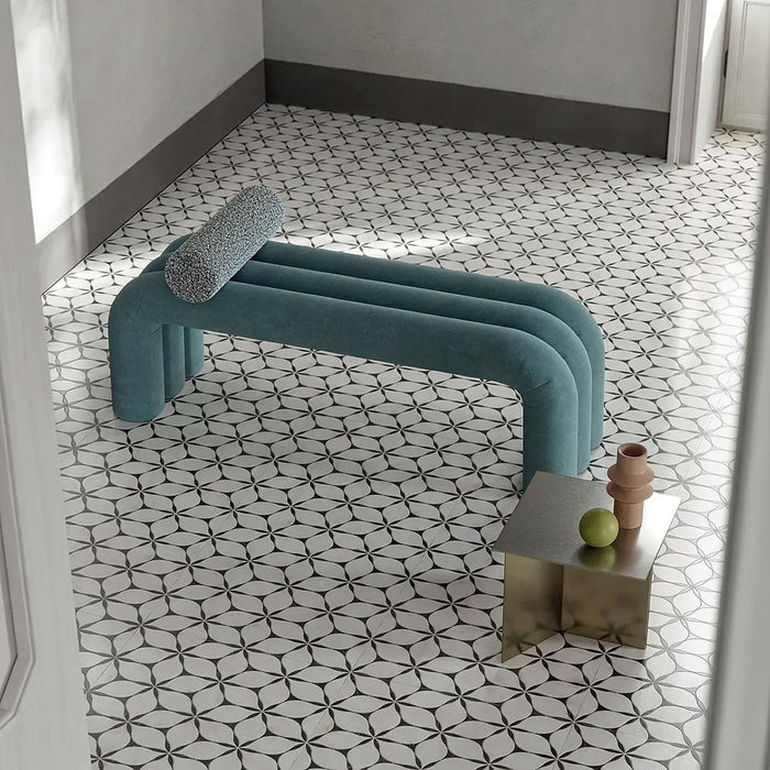 Interior space featuring Lucca Flowers 3D Décor 60 × 120cm porcelain wall and floor tiles, laid across the floor in a repeating floral geometric pattern with soft neutral tones, styled with sculptural furniture and contemporary metallic accents.