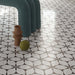 Interior space featuring Lucca Flowers 3D Décor 60 × 120cm porcelain wall and floor tiles, laid across the floor in a repeating floral geometric pattern with soft neutral tones, styled with sculptural furniture and contemporary metallic accents.