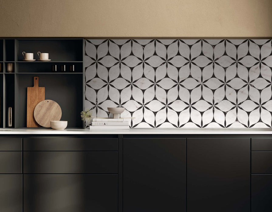 Kitchen interior featuring Lucca Flowers 3D Décor 60 × 120cm porcelain wall and floor tiles, used as a statement splashback with a repeating floral geometric pattern in soft white and black tones, paired with dark cabinetry and warm wood accents.