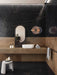 Contemporary bathroom interior featuring Lucca Precious Noir Lux 3D 60 × 120cm porcelain wall and floor tiles, combining deep black marble-effect surfaces with subtle gold veining, warm bronze tones, and minimalist fittings for a sophisticated luxury aesthetic.