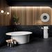 Luxury bathroom interior featuring Lucca Precious Noir Lux 3D 60 × 120cm porcelain wall and floor tiles, showcasing a deep black marble-effect finish with delicate gold veining, styled with warm wood panelling, brass fittings, and a freestanding white bath for a refined contemporary look.