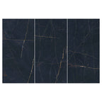 Flat lay of Lucca Precious Noir Lux 3D 60 × 120cm porcelain wall and floor tiles, showcasing a deep black marble-effect surface with fine gold veining and a polished luxury-inspired finish.