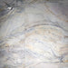 Close-up of Lucca Quartz Lux 3D 60 × 120cm porcelain wall and floor tiles, showcasing flowing marble-effect veining in soft cream, grey, and blue tones with a luxurious polished stone-inspired finish.