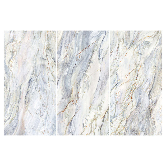 Flat lay of Lucca Quartz Lux 3D 60 × 120cm porcelain wall and floor tiles, featuring flowing marble-effect veining in soft cream, grey, and blue tones with a luxurious polished stone-inspired finish.