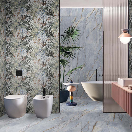 Bathroom interior featuring Lucca River Blue Matt 60 × 120cm porcelain wall and floor tiles, styled with a freestanding bath, statement veining, tropical accents, and contrasting textures for a bold, contemporary finish.