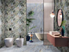 Bathroom interior featuring Lucca River Blue Matt 60 × 120cm porcelain wall and floor tiles, styled with a freestanding bath, statement veining, tropical accents, and contrasting textures for a bold, contemporary finish.
