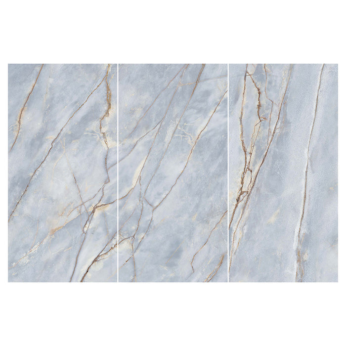Flat lay of Lucca River Blue 60 × 120cm matt porcelain wall and floor tiles, featuring soft blue-grey marble-effect tones with delicate warm veining and a refined natural stone-inspired finish.