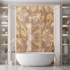 Luxury bathroom interior featuring Lumen Precious Stone Amber 60 × 120cm polished porcelain wall tiles, showcasing rich amber, honey, and smoky stone-inspired tones with dramatic crystalline movement, layered mineral detailing, and a reflective high-gloss finish, paired with a freestanding bath, brushed bronze fittings, fluted wall panelling, and soft ambient lighting.