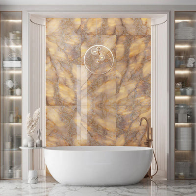 Luxury bathroom interior featuring Lumen Precious Stone Amber 60 × 120cm polished porcelain wall tiles, showcasing rich amber, honey, and smoky stone-inspired tones with dramatic crystalline movement, layered mineral detailing, and a reflective high-gloss finish, paired with a freestanding bath, brushed bronze fittings, fluted wall panelling, and soft ambient lighting.