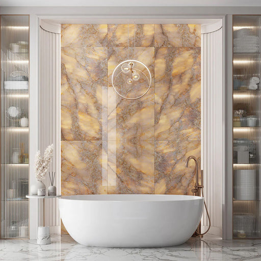 Luxury bathroom interior featuring Lumen Precious Stone Amber 60 × 120cm polished porcelain wall tiles, showcasing rich amber, honey, and smoky stone-inspired tones with dramatic crystalline movement, layered mineral detailing, and a reflective high-gloss finish, paired with a freestanding bath, brushed bronze fittings, fluted wall panelling, and soft ambient lighting.