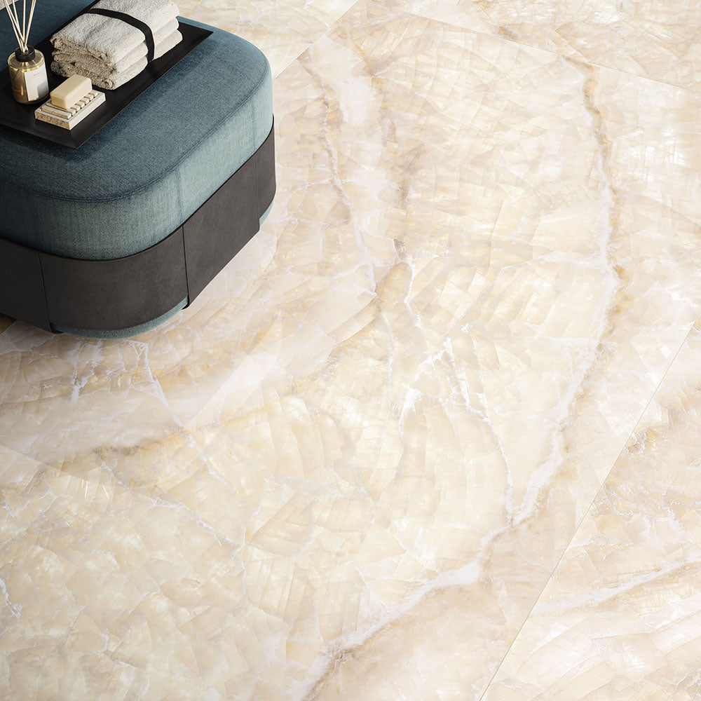 Interior floor setting featuring Lumen Precious Stone Ivory 60 × 120cm polished porcelain tiles, showcasing soft ivory and cream gemstone-inspired tones with delicate natural veining, layered crystal-like detailing, and a luxurious high-gloss finish.