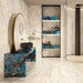 Luxury bathroom interior featuring Lumen Precious Stone Ivory 60 × 120cm polished porcelain wall and floor tiles, showcasing warm ivory and cream gemstone-inspired tones with layered crystalline detailing, soft natural veining, and a reflective high-gloss finish, paired with bold blue statement surfaces and bronze fittings.