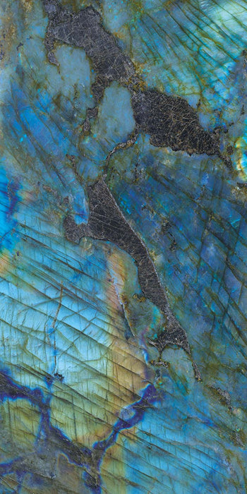 Single tile display of Lumen Precious Stone Labradorite 60 × 120cm polished porcelain tiles, featuring striking blue, teal, and charcoal gemstone-inspired tones with iridescent detailing, layered natural variation, and a luxurious high-gloss finish.