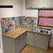 Kitchen splashback featuring Fayrouz Mini Patchwork Moroccan style tiles 15 × 15cm, combining a mix of intricate geometric and decorative patterns in rich, varied tones. Paired with shaker cabinetry and wood worktops for a warm, characterful finish.