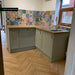 Kitchen splashback featuring Fayrouz Mini Patchwork Moroccan style tiles 15 × 15cm, combining a mix of intricate geometric and decorative patterns in rich, varied tones. Paired with shaker cabinetry and wood worktops for a warm, characterful finish.