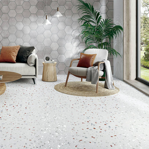 Living space featuring Gelato Colours 66x66cm terrazzo-style porcelain floor tiles, showcasing a soft neutral base with subtle multicoloured terrazzo flecks, styled with contemporary furniture, natural textures and large windows for a bright, modern interior.