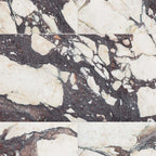 Fayrouz Viola 30.5x61cm natural marble tiles with a honed finish, installed in a staggered layout, showcasing a white base with bold burgundy and warm-toned veining, highlighting natural variation and striking stone detail.