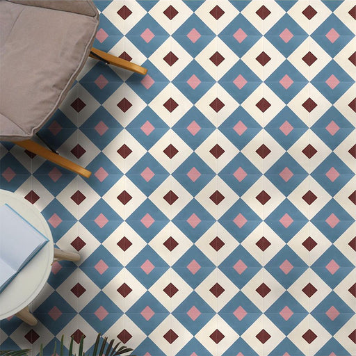 Interior floor featuring Cuba Guazzatto Moroccan-style porcelain tiles in a 20×20cm square format, arranged in a repeating geometric diamond pattern in soft blue, white, pink and burgundy tones, styled with contemporary furniture to highlight the tile’s bold yet balanced design.