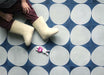 Interior setting featuring Pebbles Blue 20x20cm Moroccan style tiles, showcasing a bold circular geometric pattern in deep blue and white tones, creating a playful, graphic floor design suited to both contemporary and characterful interiors.