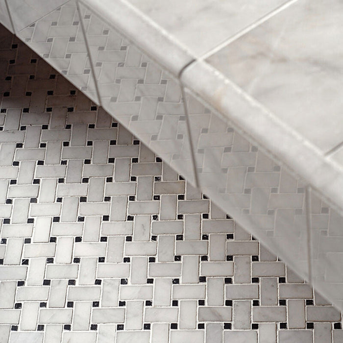 Bathroom detail featuring Fayrouz Black & White basketweave mosaic natural marble tiles with a honed finish, showcasing an intricate woven pattern with dark accents, installed alongside matching marble tiles for a cohesive, classic look.