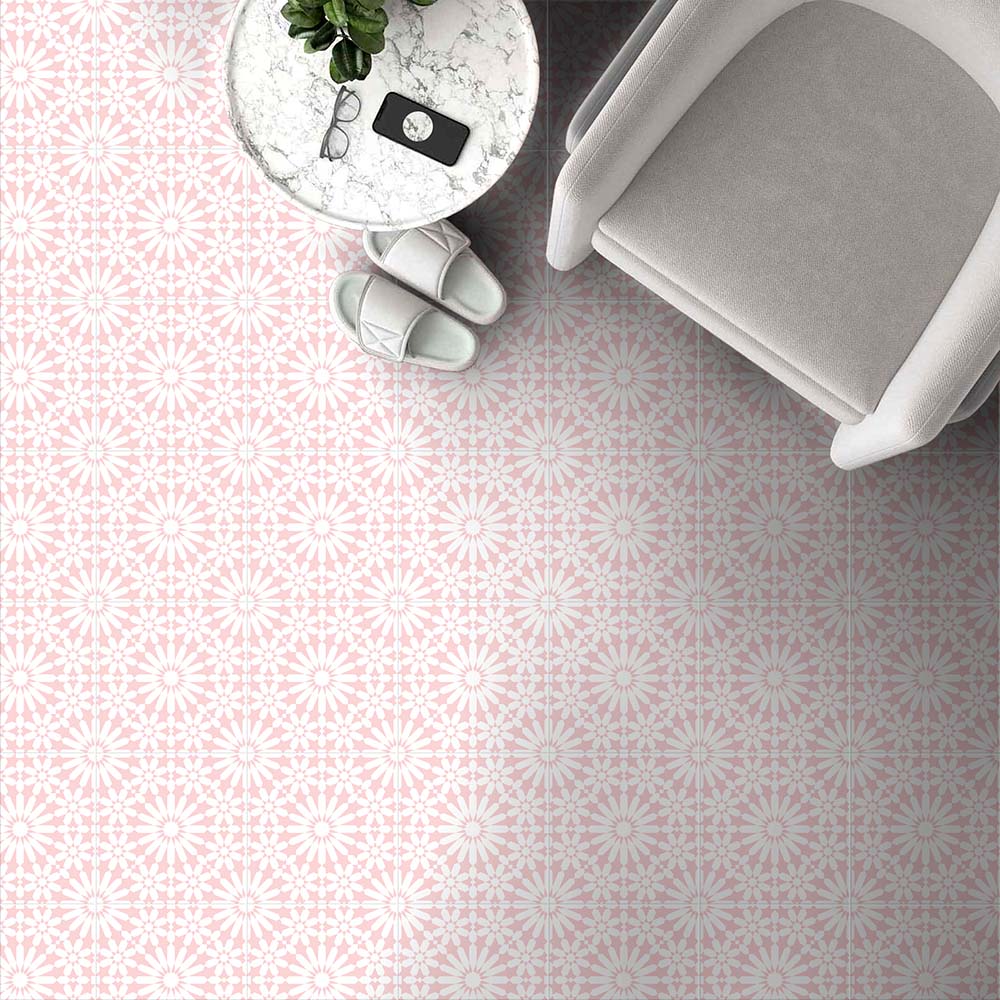 Fez Rose Pink Moroccan-style porcelain tiles laid across a floor in a soft, repeating geometric star pattern. The 20 × 20cm tiles feature delicate blush pink tones with crisp white detailing, creating a light, elegant Moroccan-inspired design. Styled here with a neutral armchair, marble side table and pale accessories, the pattern adds subtle character while maintaining a calm, airy feel—ideal for bathrooms, bedrooms, or living spaces where warmth and pattern are desired without overpowering the room.