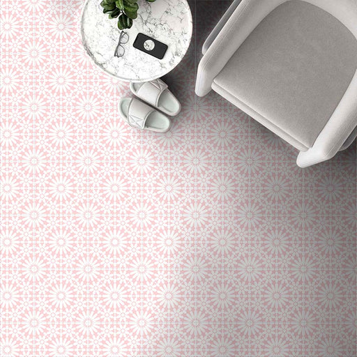 Fez Rose Pink Moroccan-style porcelain tiles laid across a floor in a soft, repeating geometric star pattern. The 20 × 20cm tiles feature delicate blush pink tones with crisp white detailing, creating a light, elegant Moroccan-inspired design. Styled here with a neutral armchair, marble side table and pale accessories, the pattern adds subtle character while maintaining a calm, airy feel—ideal for bathrooms, bedrooms, or living spaces where warmth and pattern are desired without overpowering the room.