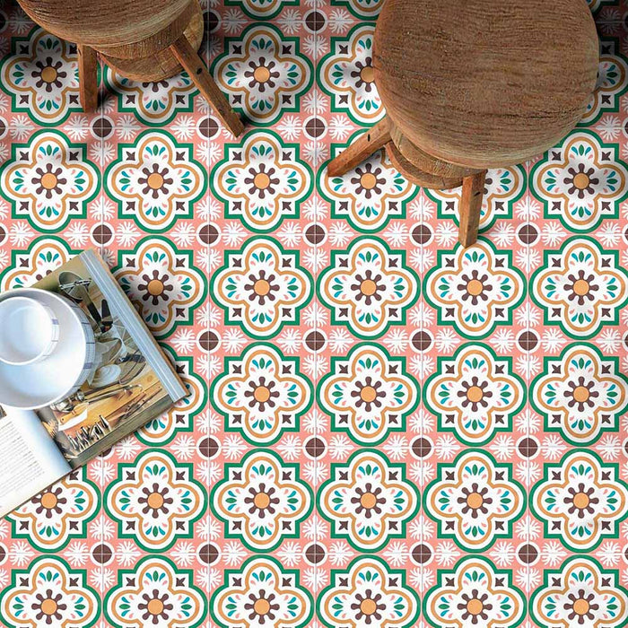 Interior floor featuring Cuba Paradise Moroccan-style porcelain tiles in a 20×20cm square format, arranged in a repeating decorative pattern with coral, green, white and brown tones, styled with wooden stools and accessories to highlight the tile’s vibrant colour palette and encaustic-style design.