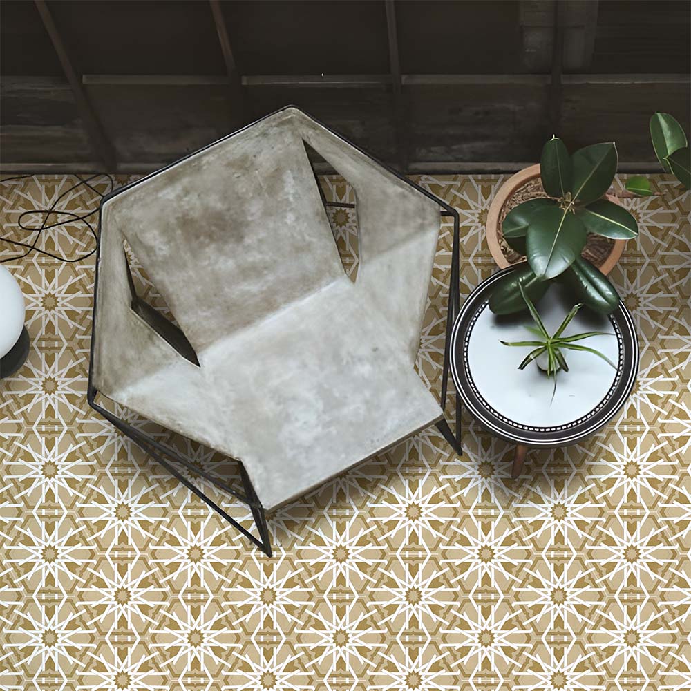Living space featuring Medina Hormuz Vintage Gold Moroccan-style hexagon porcelain floor tiles, 18.7 × 21.6 cm, laid in a bold star-inspired geometric pattern and styled with contemporary seating and indoor plants.
