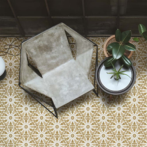 Living space featuring Medina Hormuz Vintage Gold Moroccan-style hexagon porcelain floor tiles, 18.7 × 21.6 cm, laid in a bold star-inspired geometric pattern and styled with contemporary seating and indoor plants.